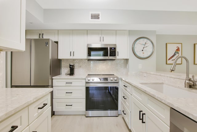 254 Village Blvd Unit 4207, Tequesta, FL 33469 - kitchen featuring appliances with stainless steel finishes, a sink, light stone countertops, and backsplash