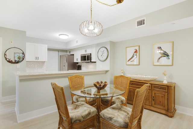 254 Village Blvd Unit 4207, Tequesta, FL 33469 - dining space with light wood-style floors, a chandelier, and baseboards