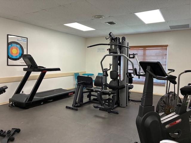 workout area featuring visible vents and a paneled ceiling