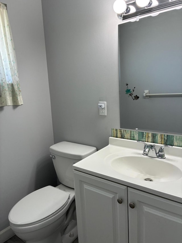 half bath with vanity and toilet
