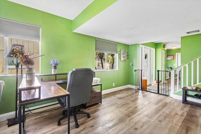 office with baseboards, wood finished floors, and visible vents