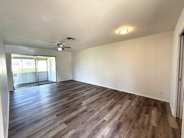 unfurnished room featuring ceiling fan, a textured ceiling, dark wood finished floors, baseboards, and visible vents