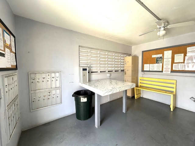 recreation room featuring concrete flooring, ceiling fan, and mail area