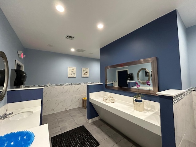 bathroom with visible vents, tile walls, a wainscoted wall, vanity, and tile patterned floors