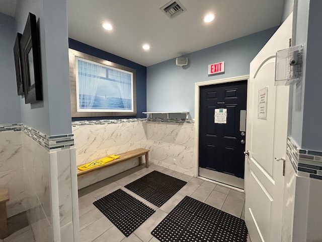 interior space featuring tile walls, a wainscoted wall, recessed lighting, and visible vents