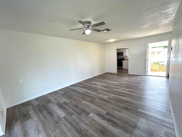 unfurnished room featuring a ceiling fan, baseboards, visible vents, and dark wood-style floors