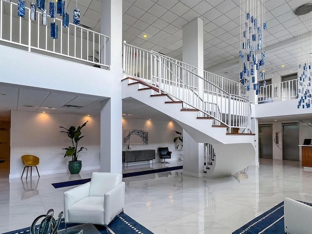 2500 E Las Olas Blvd Unit 802, Fort Lauderdale, FL 33301 - building lobby featuring a towering ceiling, stairway, and a drop ceiling