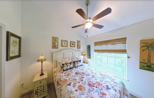 bedroom with baseboards, ceiling fan, wood finished floors, and lofted ceiling