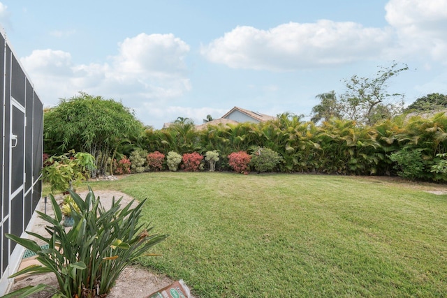 view of yard featuring glass enclosure