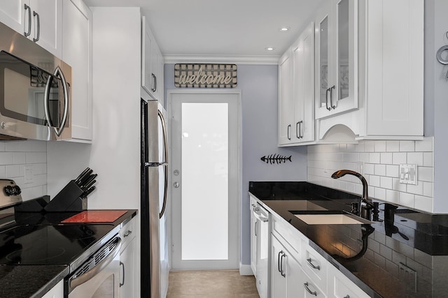 105 NE 19th Ave Unit 164, Deerfield Beach, FL 33441 - kitchen featuring backsplash, a sink, glass insert cabinets, stainless steel appliances, and white cabinetry