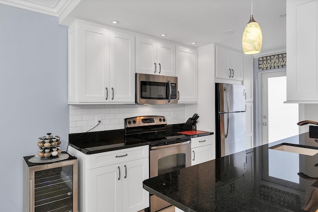 105 NE 19th Ave Unit 164, Deerfield Beach, FL 33441 - kitchen featuring backsplash, appliances with stainless steel finishes, a sink, white cabinets, and wine cooler