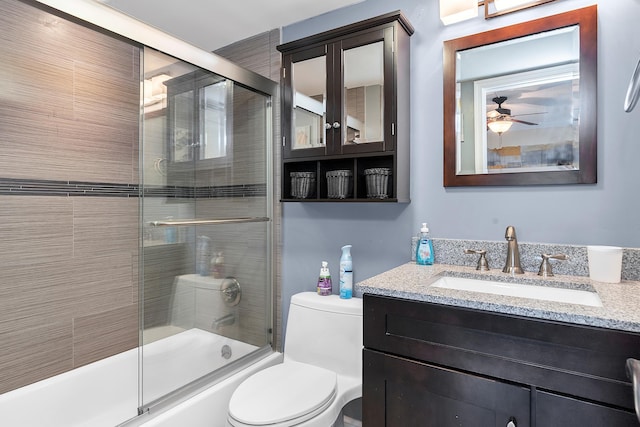 105 NE 19th Ave Unit 164, Deerfield Beach, FL 33441 - bathroom featuring vanity, a ceiling fan, enclosed tub / shower combo, and toilet