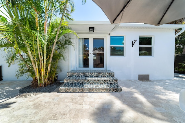 425 32nd St, West Palm Beach, FL 33407 - doorway to property featuring french doors and stucco siding