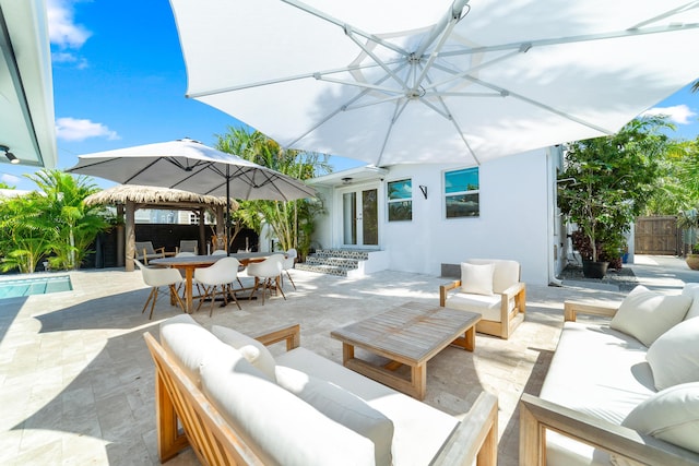 425 32nd St, West Palm Beach, FL 33407 - view of patio featuring an outdoor living space, a fenced backyard, french doors, and outdoor dining area