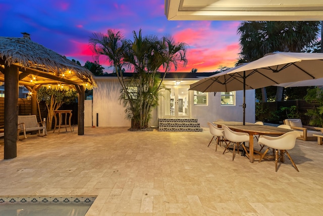 425 32nd St, West Palm Beach, FL 33407 - patio terrace at dusk with fence and a gazebo