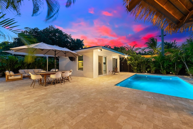 425 32nd St, West Palm Beach, FL 33407 - pool at dusk with an outdoor pool, a patio, and outdoor lounge area