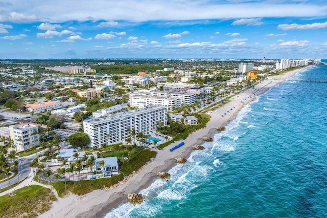aerial view with a beach view, a water view, and a city view