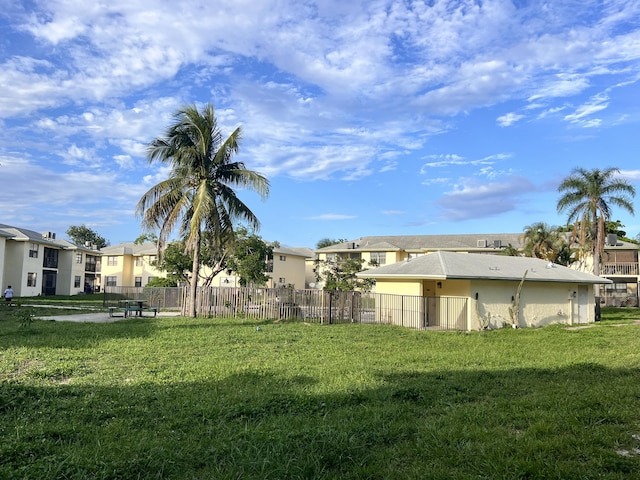 view of yard featuring fence and a residential view