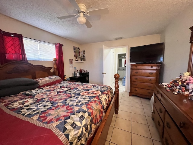 bedroom with light tile patterned floors, a ceiling fan, and a textured ceiling