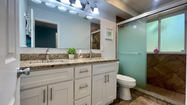 1044 Nin St, Orlando, FL 32835 - full bathroom with double vanity, a stall shower, and toilet