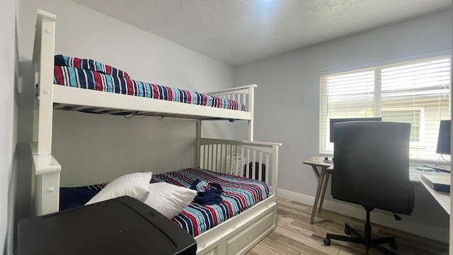 1044 Nin St, Orlando, FL 32835 - bedroom featuring wood finished floors, an office area, baseboards, and a textured ceiling