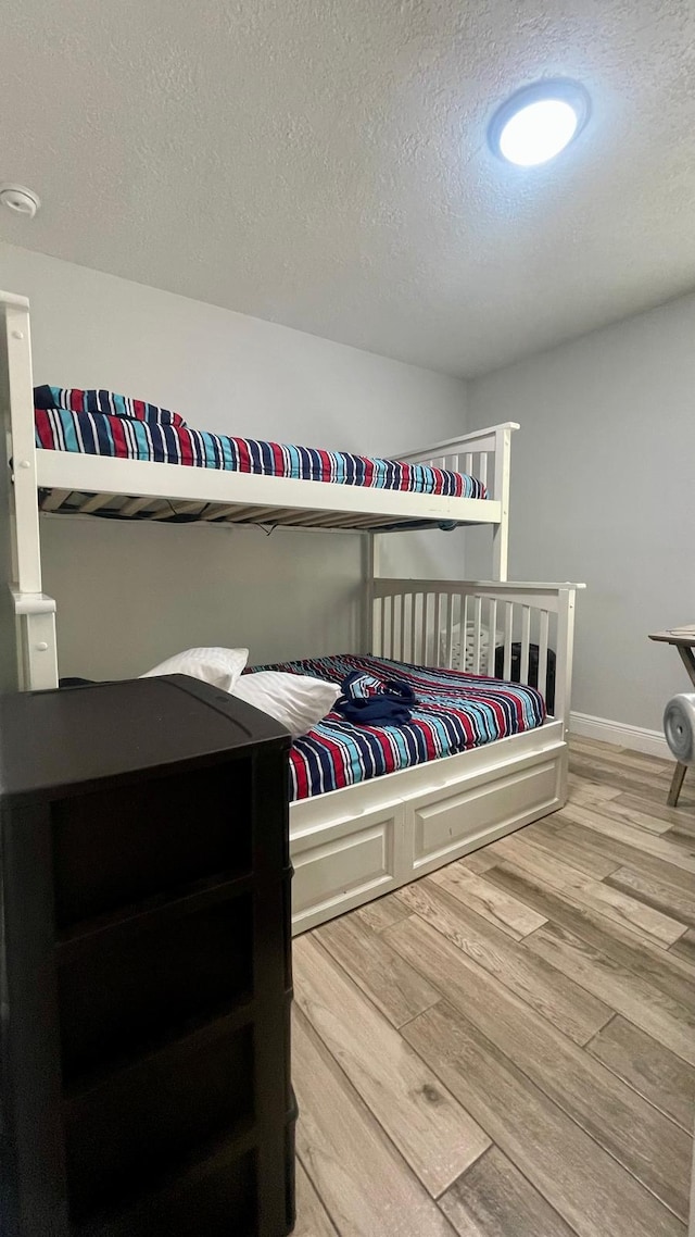 1044 Nin St, Orlando, FL 32835 - bedroom featuring wood finished floors, a textured ceiling, and baseboards