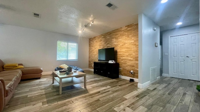 1044 Nin St, Orlando, FL 32835 - living room featuring baseboards, wood finished floors, and a textured ceiling
