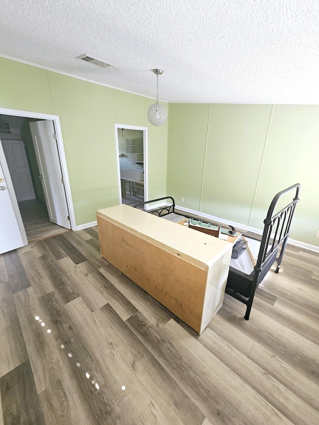 17120 NW 38th Ave, Okeechobee, FL 34972 - interior space featuring visible vents, hanging light fixtures, a textured ceiling, and light wood finished floors