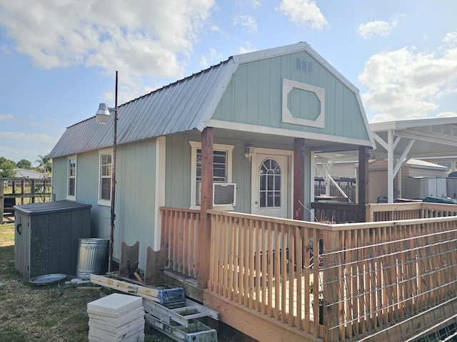 17120 NW 38th Ave, Okeechobee, FL 34972 - rear view of house with metal roof, a gambrel roof, and covered porch