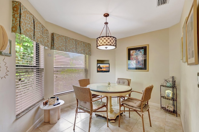 dining room featuring baseboards, visible vents, and light tile patterned floors