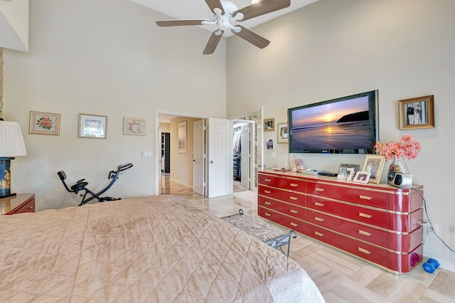 bedroom with ceiling fan and a high ceiling