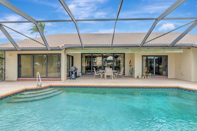 rear view of property featuring an outdoor pool, a patio area, stucco siding, and a tile roof