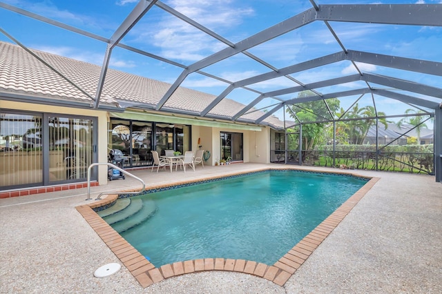pool featuring glass enclosure, ceiling fan, and a patio area