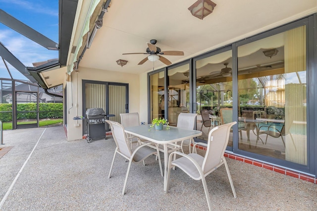 view of patio / terrace featuring a ceiling fan, a lanai, outdoor dining area, and a grill
