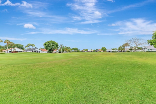 view of yard with view of golf course and a residential view