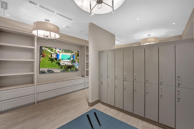 interior space with an inviting chandelier and light wood-type flooring