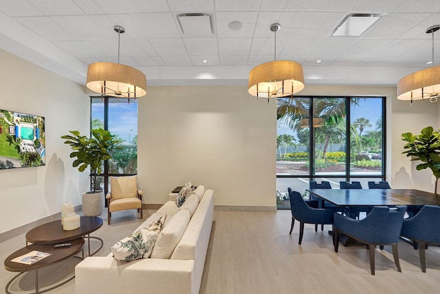 dining area with baseboards, visible vents, a healthy amount of sunlight, and wood finished floors