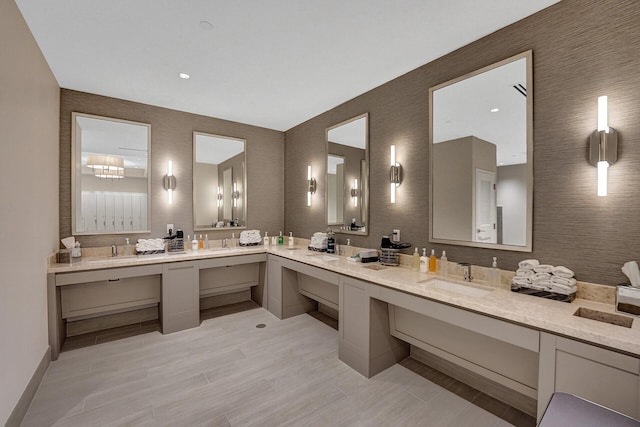 bathroom with a sink, double vanity, and wood finished floors