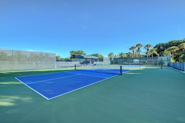 view of tennis court featuring fence