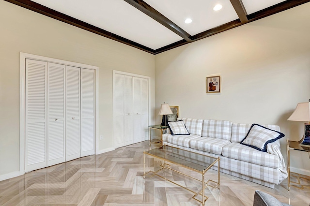 living room with baseboards and beamed ceiling