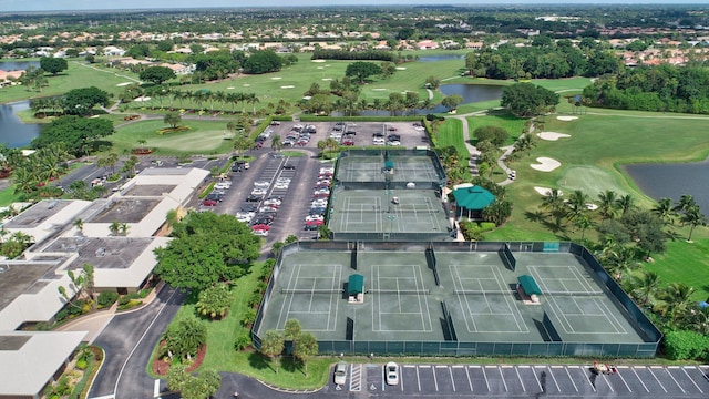 bird's eye view with a water view and view of golf course