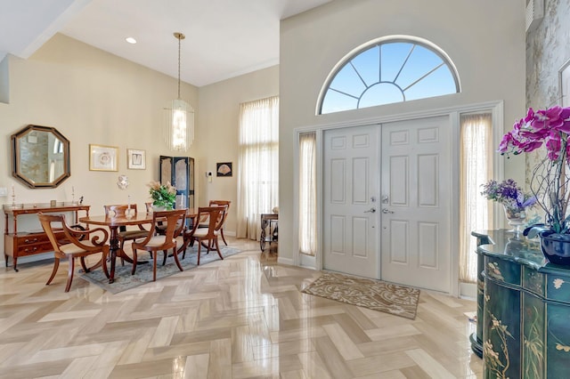 foyer with recessed lighting, a high ceiling, and a healthy amount of sunlight