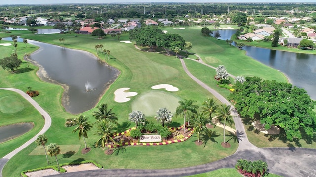 birds eye view of property with a water view, view of golf course, and a residential view