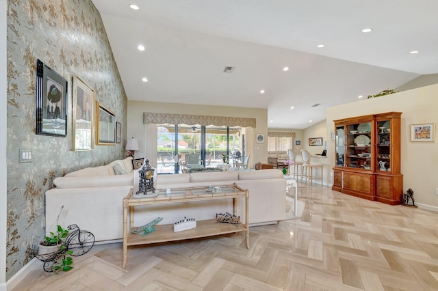 living area featuring baseboards, wallpapered walls, lofted ceiling, an accent wall, and recessed lighting