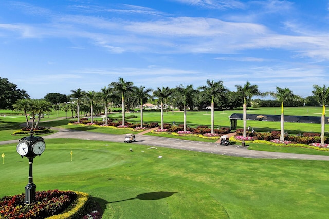 view of community featuring a lawn and golf course view