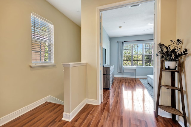 112 Osceola Ln, Jupiter, FL 33458 - hallway with baseboards, wood finished floors, and visible vents