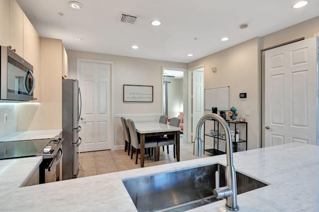 112 Osceola Ln, Jupiter, FL 33458 - kitchen with visible vents, recessed lighting, a sink, light tile patterned floors, and stainless steel appliances