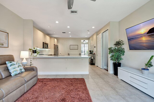112 Osceola Ln, Jupiter, FL 33458 - living area featuring light tile patterned floors, baseboards, recessed lighting, and visible vents