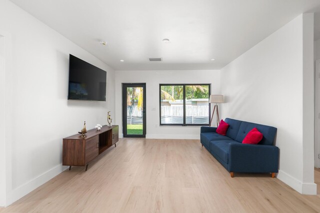 303/305 De Carie, Delray Beach, FL 33444 - living room with recessed lighting, baseboards, visible vents, and light wood-style floors