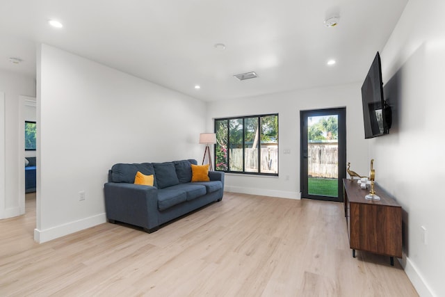303/305 De Carie, Delray Beach, FL 33444 - living room featuring light wood-style floors and baseboards